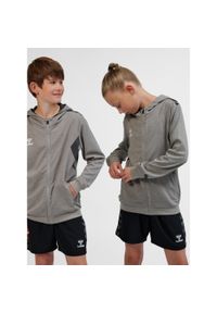 Dziecięca poliestrowa kurtka dresowa z kapturem i zamkiem błyskawicznym Hummel A. Typ kołnierza: kaptur. Kolor: szary. Materiał: poliester, dresówka. Sport: joga i pilates #1
