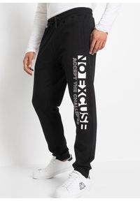 bonprix - Spodnie ze sportowym nadrukiem uszyte z czystej bawełny. Kolor: czarny. Materiał: bawełna. Wzór: nadruk. Styl: sportowy #1