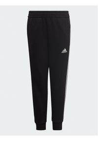 Adidas - adidas Spodnie dresowe adidas Essential 3-Stripes Joggers H65796 Czarny Regular Fit. Kolor: czarny. Materiał: bawełna