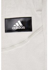 Adidas - adidas spodnie dresowe damskie kolor beżowy. Kolor: beżowy. Materiał: dresówka #2