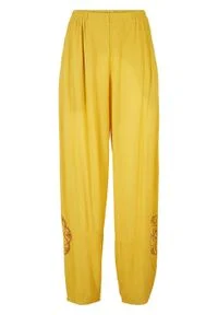 Spodnie z szerokimi nogawkami, wygodnym paskiem w talii i nadrukiem z boku bonprix żółty curry. Kolor: żółty. Wzór: nadruk #1