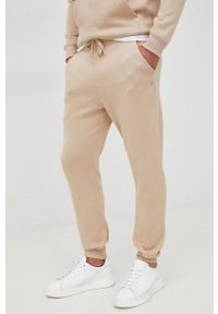 G-Star RAW - G-Star Raw spodnie męskie gładkie. Kolor: beżowy. Materiał: poliester. Wzór: gładki