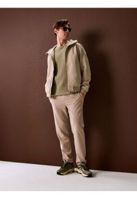 Sinsay - Spodnie dresowe jogger ottoman - beżowy. Kolor: beżowy. Materiał: dresówka