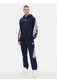 Adidas - adidas Spodnie dresowe Future Icons Allover Print IJ8853 Granatowy Regular Fit. Kolor: niebieski. Materiał: syntetyk. Wzór: nadruk