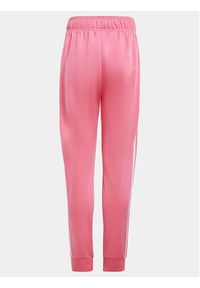 Adidas - adidas Spodnie dresowe adicolor SST IN8492 Różowy Regular Fit. Kolor: różowy. Materiał: syntetyk #5