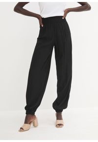 bonprix - Spodnie palazzo z lejącej się wiskozy. Kolor: czarny. Materiał: wiskoza #1