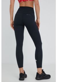 Adidas - adidas legginsy treningowe Yoga Essentials damskie kolor czarny gładkie. Kolor: czarny. Materiał: skóra, dzianina, materiał. Wzór: gładki. Sport: fitness