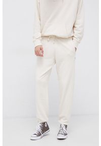 Reebok Classic Spodnie męskie gładkie. Kolor: beżowy. Materiał: bawełna. Wzór: gładki