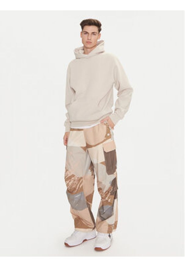 Champion Spodnie dresowe 220414 Beżowy Loose Fit. Kolor: beżowy. Materiał: bawełna