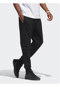 Adidas - adidas Spodnie dresowe Essentials HZ2218 Czarny Regular Fit. Kolor: czarny. Materiał: bawełna