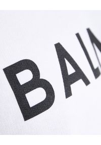 Balmain - BALMAIN - Biała bluza z nadrukiem logo. Kolor: biały. Materiał: bawełna, prążkowany. Długość: długie. Wzór: nadruk. Styl: klasyczny