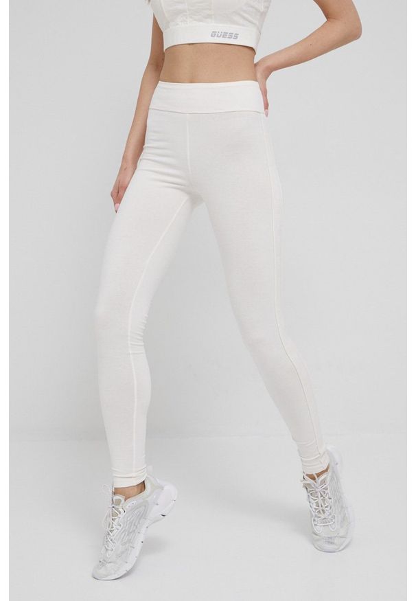 Guess legginsy damskie kolor beżowy z aplikacją. Stan: podwyższony. Kolor: beżowy. Materiał: poliester. Wzór: aplikacja