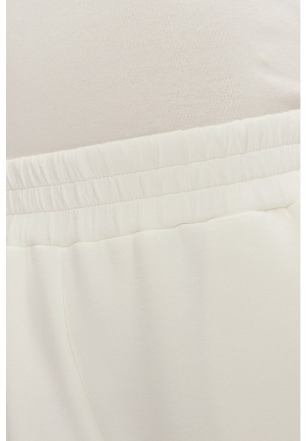 Guess - GUESS Dresowe damskie spodnie w kolorze ecru Cecilia Scuba, Rozmiar M. Kolor: beżowy. Materiał: dresówka