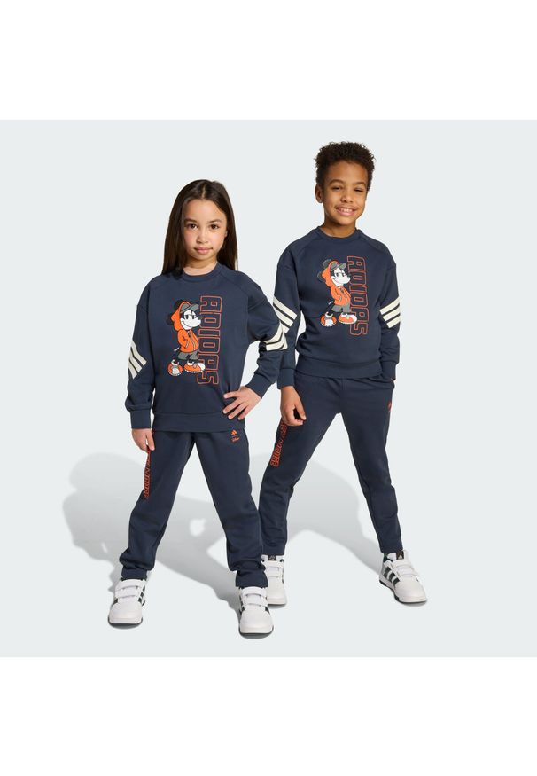Adidas - Zestaw Disney Mickey Mouse Jogger Kids. Kolor: żółty, pomarańczowy, wielokolorowy, fioletowy. Wzór: motyw z bajki