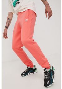 adidas Originals spodnie dresowe HG3903 męskie kolor pomarańczowy gładkie. Kolor: pomarańczowy. Materiał: dresówka. Wzór: gładki #1