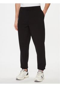 Calvin Klein Spodnie dresowe Embossed Logo K10K112198 Czarny Relaxed Fit. Kolor: czarny. Materiał: bawełna #1