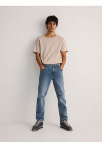 Reserved - Jeansy slim z efektem sprania - niebieski. Kolor: niebieski #1