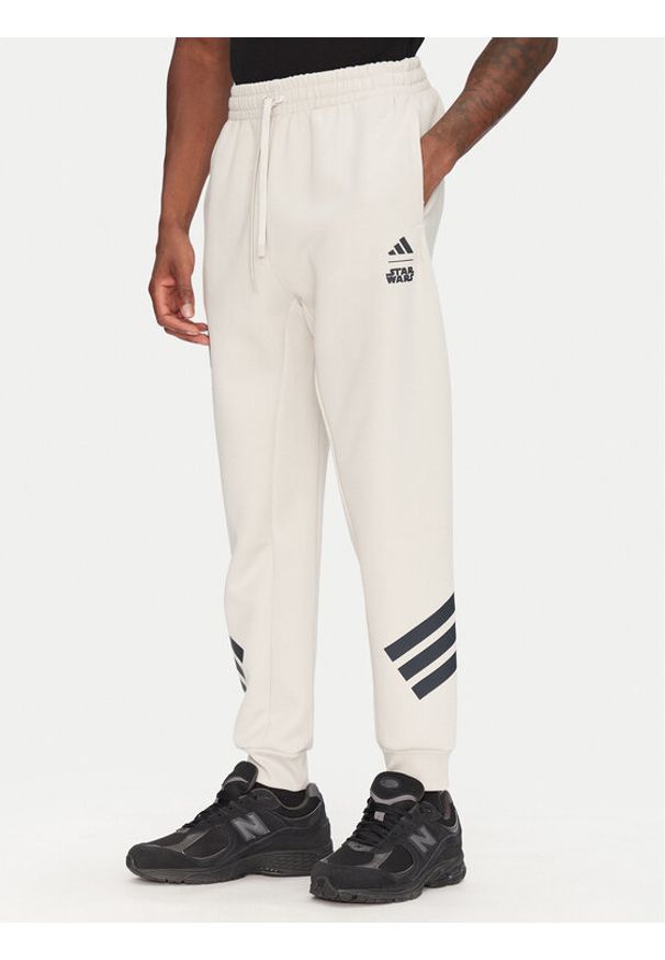 Adidas - adidas Spodnie dresowe Star Wars The Mandalorian™ JI5723 Beżowy Regular Fit. Kolor: beżowy. Materiał: syntetyk. Wzór: motyw z bajki