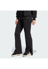 Adidas - Spodnie ALL SZN Soft Lux Flared. Kolor: czarny