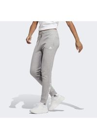 Adidas - Essentials Linear French Terry Cuffed Pants. Kolor: szary, wielokolorowy, biały. Materiał: dresówka