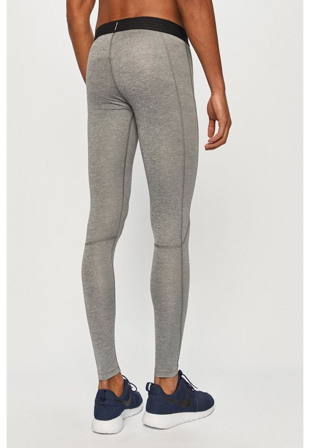 Nike - Legginsy. Kolor: szary. Materiał: tkanina, dzianina, skóra, włókno. Technologia: Dri-Fit (Nike)