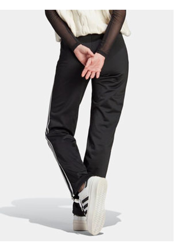 Adidas - adidas Spodnie dresowe adicolor Classics Firebird IL8763 Czarny Regular Fit. Kolor: czarny. Materiał: syntetyk