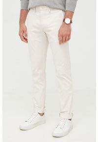 TOMMY HILFIGER - Tommy Hilfiger spodnie męskie kolor beżowy w fasonie chinos. Kolor: beżowy. Materiał: bawełna
