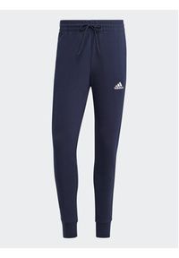 Adidas - adidas Spodnie dresowe Essentials French Terry Tapered Cuff 3-Stripes Joggers IC9406 Niebieski Regular Fit. Kolor: niebieski. Materiał: bawełna