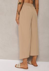Renee - Beżowe Spodnie High Waist z Szerokimi Nogawkami z Wiskozą Wykończone Gumką w Talii Crisantas. Okazja: na spotkanie biznesowe, na co dzień. Stan: podwyższony. Kolor: beżowy. Materiał: wiskoza. Styl: casual, elegancki, biznesowy
