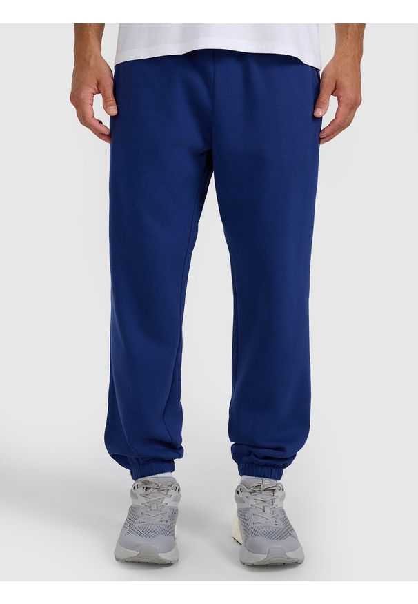 4f - 4F Spodnie dresowe joggery męskie - granatowe XL. Kolor: niebieski. Materiał: dresówka. Wzór: gładki, ze splotem