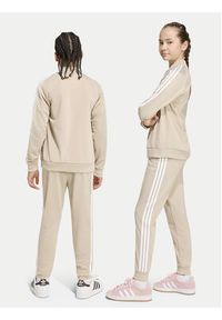 Adidas - adidas Spodnie dresowe Sst Track IA2239 Beżowy jasny Regular Fit. Kolor: beżowy. Materiał: syntetyk #4
