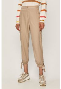 Tommy Jeans - Spodnie. Kolor: beżowy. Materiał: tkanina, len, wiskoza, bawełna. Wzór: gładki #1