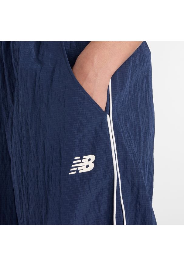 Spodnie damskie New Balance WB61Z1E6NNY – granatowe. Kolor: niebieski. Materiał: materiał, tkanina, nylon