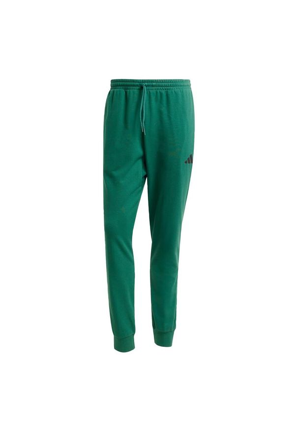 Adidas - Spodnie Essentials Feel Cozy French Terry. Kolor: zielony, czarny, wielokolorowy. Materiał: dresówka, materiał