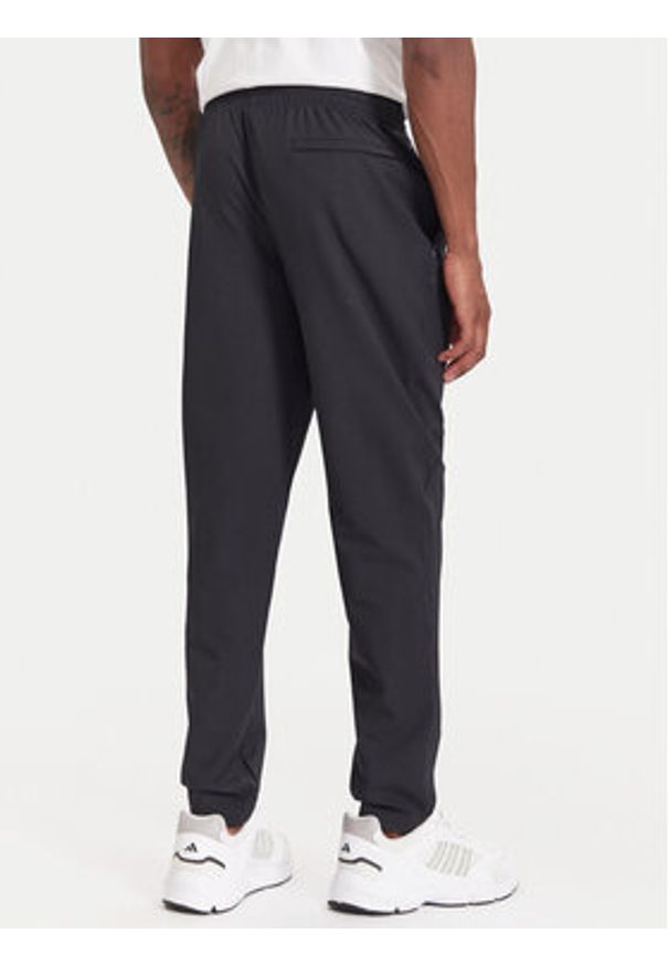 Under Armour Spodnie dresowe Unstoppable 6003861 Czarny Loose Fit. Kolor: czarny. Materiał: syntetyk