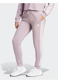 Adidas - adidas Spodnie dresowe Essentials 3-Stripes IR5379 Różowy Slim Fit. Kolor: różowy. Materiał: bawełna #1