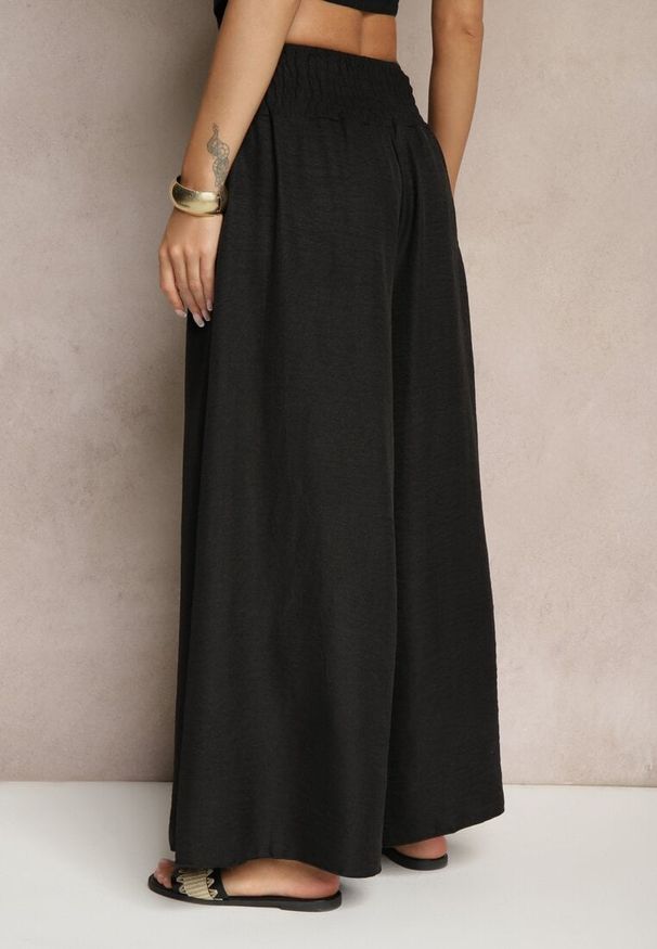 Renee - Czarne Szerokie Spodnie High Waist z Szeroką Gumą w Pasie Korissele. Okazja: na co dzień. Stan: podwyższony. Kolor: czarny. Materiał: guma. Wzór: aplikacja. Styl: elegancki, casual