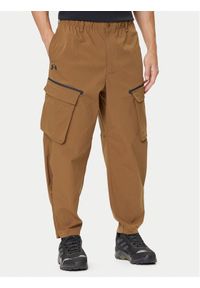 Under Armour Spodnie materiałowe Unstoppable 1388827 Brązowy Loose Fit. Kolor: brązowy. Materiał: syntetyk
