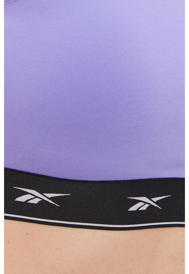 Reebok - Biustonosz sportowy. Kolor: fioletowy. Materiał: skóra. Rodzaj stanika: wyciągane miseczki