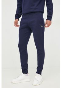 Lacoste spodnie dresowe męskie kolor granatowy gładkie XH9624-132. Kolor: niebieski. Materiał: dresówka. Wzór: gładki