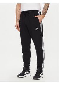 Adidas - adidas Spodnie dresowe Essentials French Terry Tapered Cuff 3-Stripes Joggers HA4337 Czarny Regular Fit. Kolor: czarny. Materiał: bawełna #1