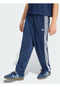 Adidas - adidas Spodnie dresowe Firebird HZ6650 Granatowy Regular Fit. Kolor: niebieski. Materiał: syntetyk #1
