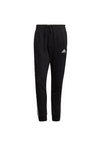 Adidas - Spodnie męskie adidas Essentials Tapered Cuff 3 Stripes. Kolor: wielokolorowy, biały, czarny. Materiał: bawełna, poliester, wiskoza. Wzór: paski. Sport: joga i pilates