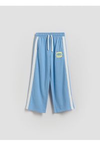 Reserved - Dresowe spodnie z lampasem - niebieski. Kolor: niebieski. Materiał: dresówka #1