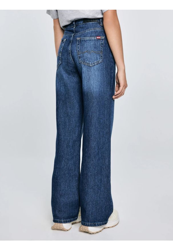 Big-Star - Jeansy dziewczęce z szeroką nogawką granatowe Natalie 514. Okazja: na spacer, na uczelnię. Stan: podwyższony. Kolor: niebieski. Materiał: jeans. Styl: elegancki, młodzieżowy