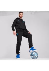 Puma - Spodnie dresowe OM 2024/25. Kolor: niebieski, czarny, wielokolorowy. Materiał: dresówka. Sport: piłka nożna