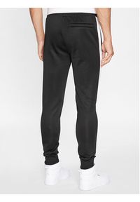 Puma Spodnie dresowe Iconic T7 530098 Czarny Regular Fit. Kolor: czarny. Materiał: bawełna