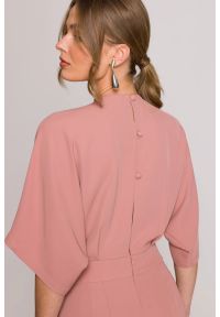 Stylove - Elegancki kombinezon damski z kopertowym dekoltem różany. Okazja: na randkę, na spotkanie biznesowe, na komunię, na ślub cywilny, na wesele, na imprezę. Kolor: różowy. Materiał: tkanina. Długość rękawa: krótki rękaw. Długość: krótkie. Wzór: gładki. Styl: elegancki #5