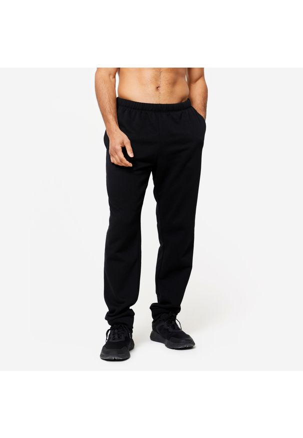 DOMYOS - Spodnie dresowe męskie Domyos Gym & Pilates 100. Kolor: czarny. Materiał: poliester, bawełna, materiał. Wzór: ze splotem. Sport: joga i pilates