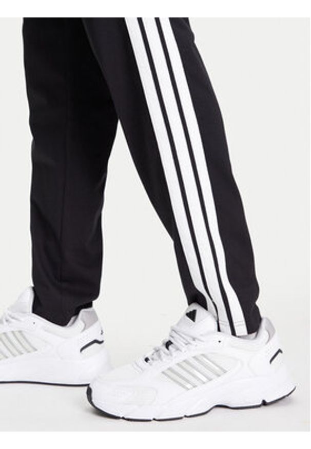 Adidas - adidas Spodnie dresowe Essentials 3-Stripes JE6430 Czarny Regular Fit. Kolor: czarny. Materiał: bawełna